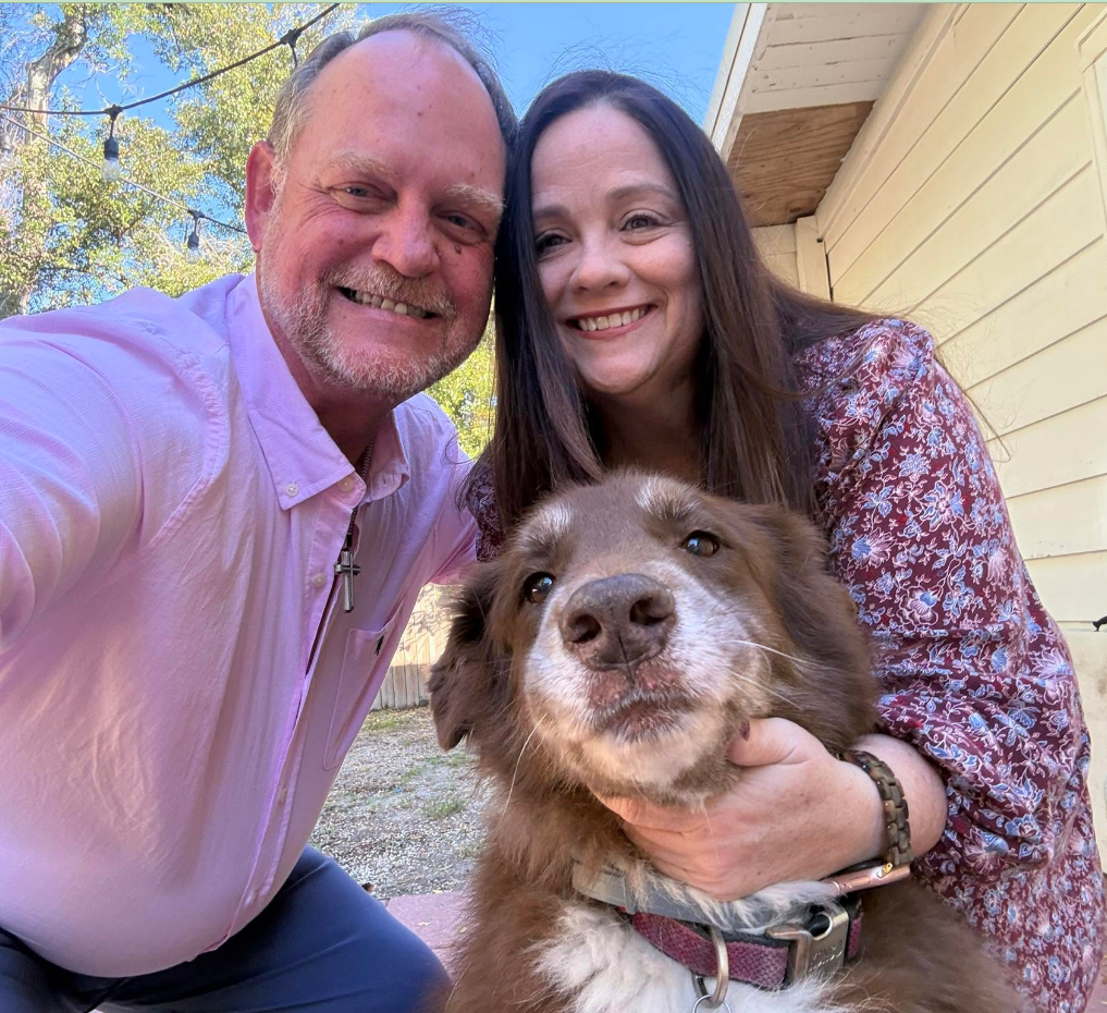 Michael and Jan smiling with their dog
